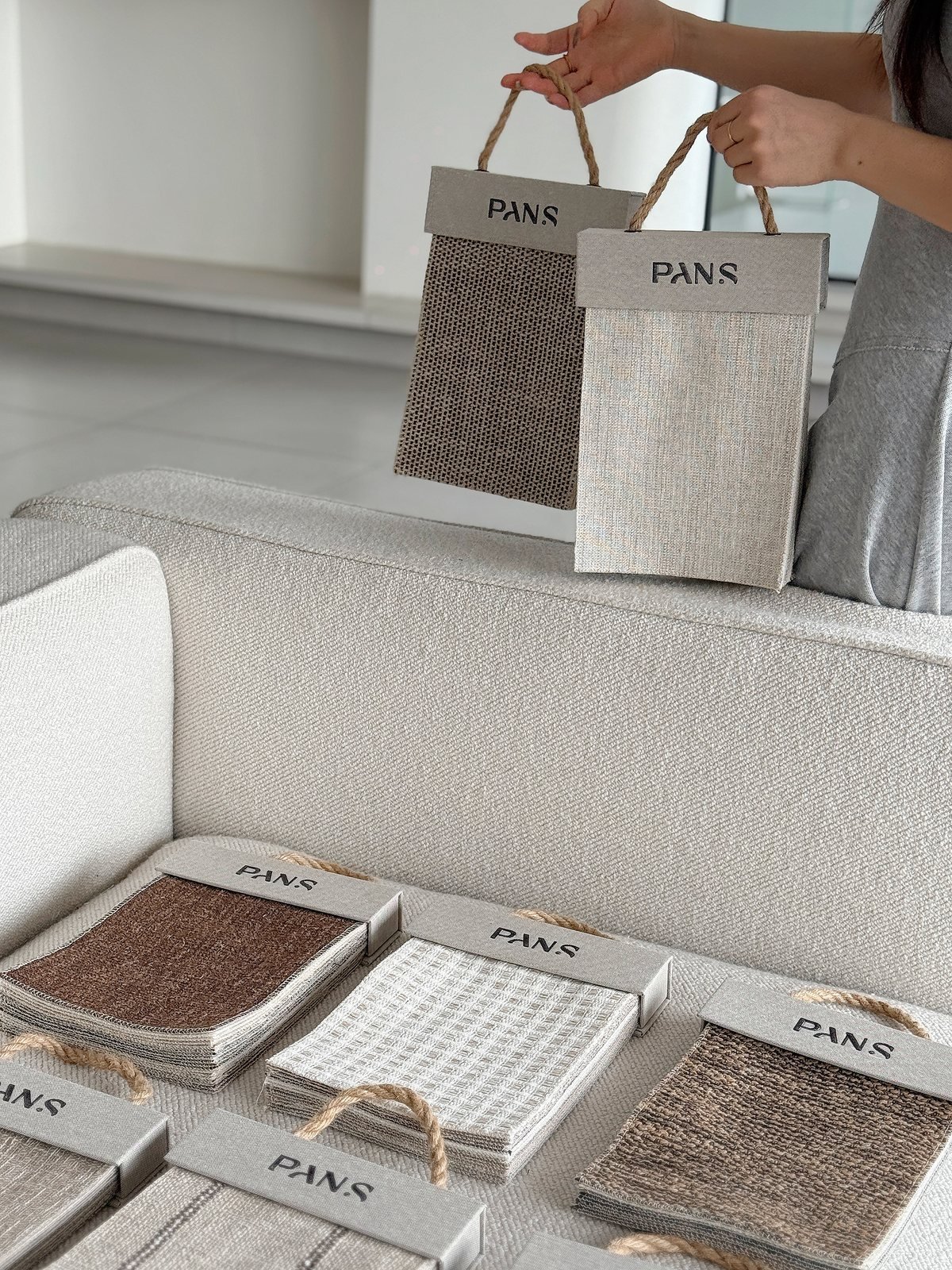 Ksino neutral small sample books arranged on a sofa