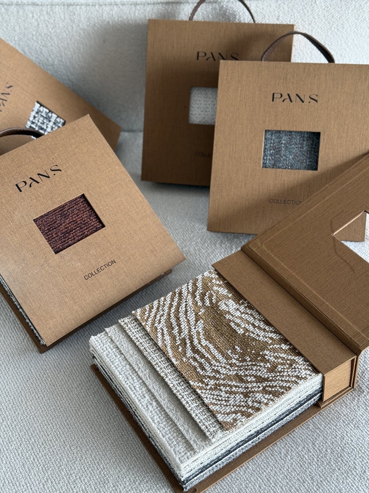 Close detail of Ksino woven sample book and fabric swatches