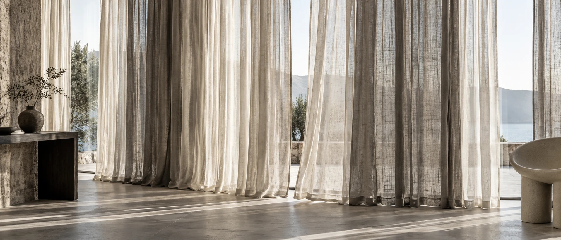 Layered ivory and taupe linen curtains glowing in daylight